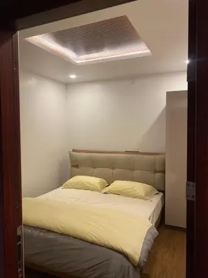 a bedroom with a large bed with a light at eagle resort in Ketti