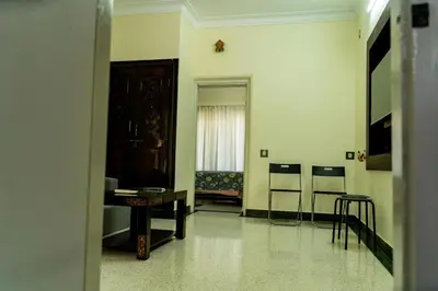 a hallway with a room with a table and a window at Akshaya - Charming 2BHK apartment with scenic view in Mysore