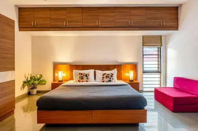 a bedroom with a large bed and a red couch at Senaro Luxury Farm in Agali