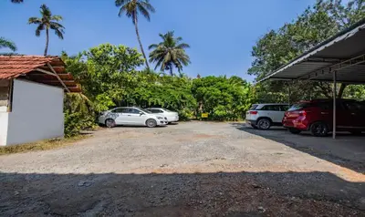 a group of cars parked in a parking lot at Treebo Sadhoo Heritage in Kannur