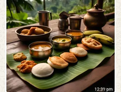 a plate of food on a wooden table with food at Mayoorvihar home stay Sulthaan Bathery Wayanad Kerala in Sultan Bathery