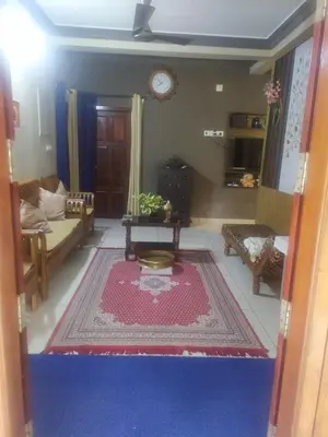 a living room with a couch and a table at Mayoorvihar home stay Sulthaan Bathery Wayanad Kerala in Sultan Bathery