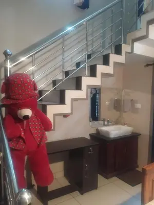 a red teddy bear in a bathroom with a staircase at Mayoorvihar home stay Sulthaan Bathery Wayanad Kerala in Sultan Bathery