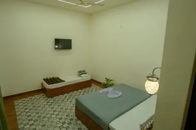 a small room with a bed and a couch at Swastha Royal Resort Wayanad in Kaniyāmbetta