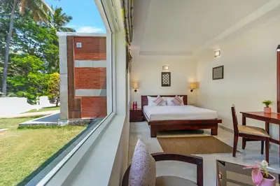 a bedroom with a bed and a large window at Mango Hill Coimbatore-Near Isha Yoga in Alāndurai
