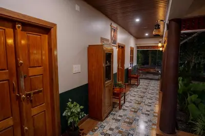 a hallway of a home with a tile floor at Swastha Heritage Homestays Wayanad in Kaniyāmbetta