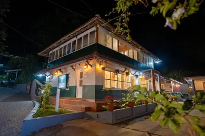 a building with lights on it at night at Swastha Heritage Homestays Wayanad in Kaniyāmbetta