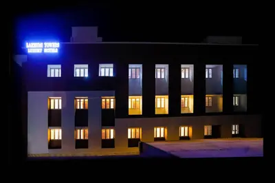 a building with lit up windows at night at Hotel Lakshmi Towers in Kāngayam