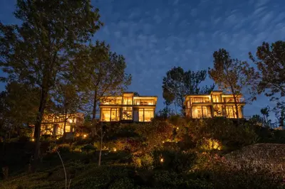 a house on top of a hill at night at LohonoStays Amani Villa 11B in Coonoor