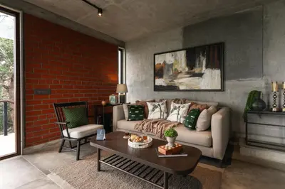 a living room with a couch and a table at LohonoStays Amani Villa 12A in Coonoor