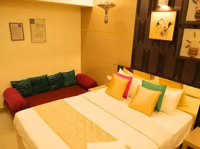 a bedroom with a large bed with colorful pillows at Paradise Homestay in Alwaye