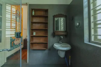 a bathroom with a sink and a mirror at Bougainville, Wayanad in Kalpetta