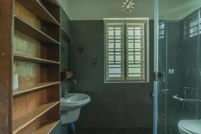 a bathroom with a toilet and a sink and a shower at Bougainville, Wayanad in Kalpetta