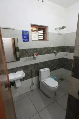 a bathroom with a toilet and a sink at Wayanad One in Wayanad