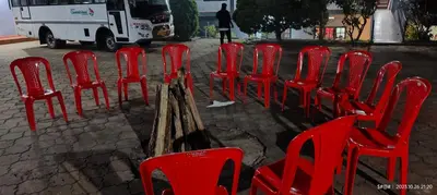 a group of red chairs sitting on a street at View Point Stay Coorg in Madikeri