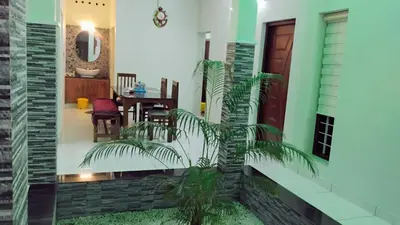 a hallway of a house with a door and a plant at Cozy Corner in Alwaye