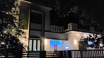 a building with a lit up window at night at Cozy Corner in Alwaye