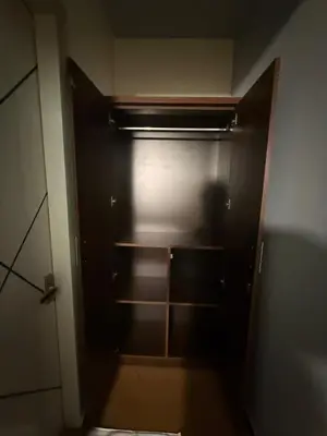 an empty closet with a black door in a room at Humming Bird suite in Kotagiri