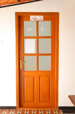 a wooden door with a sign on it at Coimbatore's Chettinad Courtyard By Shivalaya Stays in Alāndurai