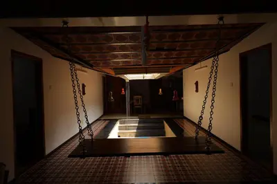 an empty corridor with a swing in a building at Coimbatore's Chettinad Courtyard By Shivalaya Stays in Alāndurai