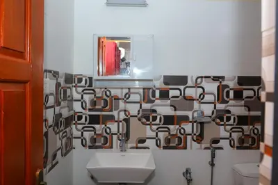a bathroom with a sink and a mirror at Coimbatore's Chettinad Courtyard By Shivalaya Stays in Alāndurai