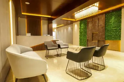 a waiting area with chairs and a table in a lobby at Balu Residency - A Business Class Hotel in Coimbatore