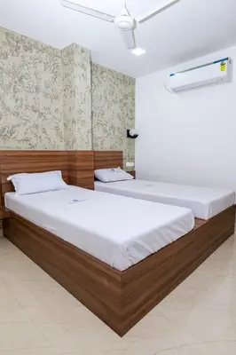 a bedroom with two beds in a room at Balu Residency - A Business Class Hotel in Coimbatore