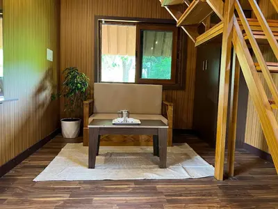 a room with a table and a chair and a window at Jungle flare in Hampāpura