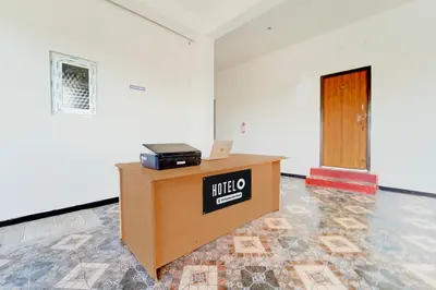 an office with a desk with a laptop on it at Super Hotel O Neelambur Near PSG ITech in Coimbatore
