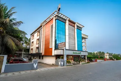 a building on the side of a street at Excellency Airport Hotel in Angamali