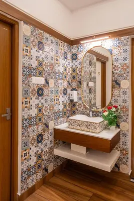 a bathroom with a sink and a mirror at Excellency Airport Hotel in Angamali