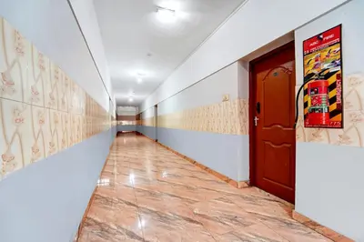 a long corridor with a door and a tile floor at Super Hotel O Tiruppur Near Railway station in Tiruppūr