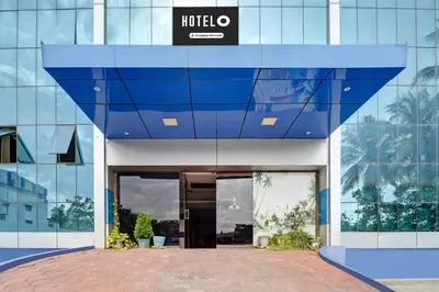 a building with a sign on the side of it at Super Hotel O Tiruppur Near Railway station in Tiruppūr