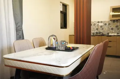a dining room table with chairs and a mixer on it at Mysore Elite in Mysore