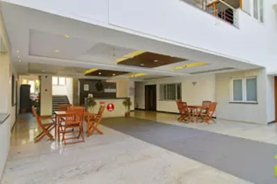 a room with chairs and tables in a building at Horizon Heights Apartment in Coimbatore