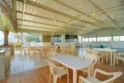 a dining area with tables and chairs in a building at Horizon Heights Apartment in Coimbatore