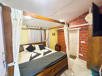 a bedroom with a canopy bed in a room at The Plum Castle in Kodaikānāl