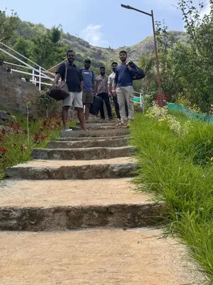 a group of people walking up some stairs at The Plum Castle in Kodaikānāl