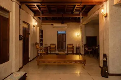 a room with a bench in the middle of a room at Reverie in North Paravur