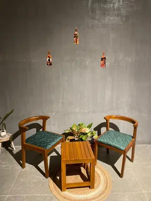 two chairs and a table in a room at Rustic Nestle, Tirupur in Tiruppūr