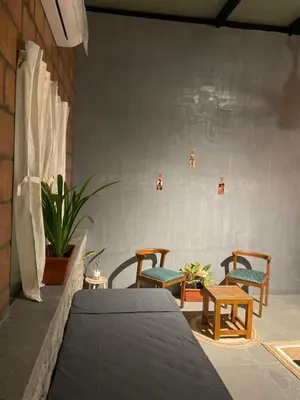 a room with two chairs and a table and someitures at Rustic Nestle, Tirupur in Tiruppūr