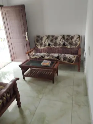 a living room with a couch and a coffee table at Thrikarthika appartments in Guruvāyūr