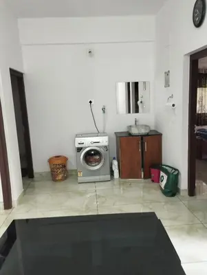 a kitchen with a washing machine in a room at Thrikarthika appartments in Guruvāyūr