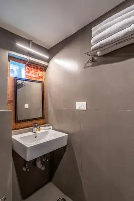 a bathroom with a sink and a mirror at Finch,Kotagiri in Kotagiri