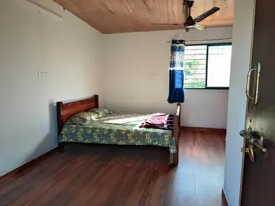 a bedroom with a bed in a room with a window at Bandipur Jaguar Homestay in Bandipūr