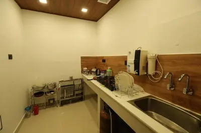 a kitchen with a sink and a counter top at JS homes vattavada in Vattavada
