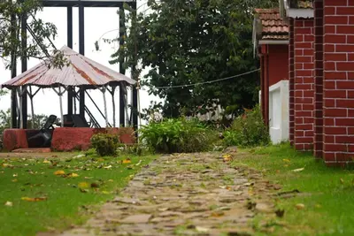 a garden with a gazebo in the yard at Estate Bungalow with Waterfall, Mountain & Valley Views in Kotagiri