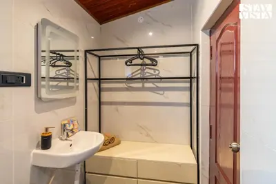 a bathroom with a sink and a glass shower at StayVista at Valley Whispers with BBQ & Bonfire in Ooty