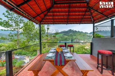 a table with plates of food on it on a patio at StayVista at Valley Whispers with BBQ & Bonfire in Ooty