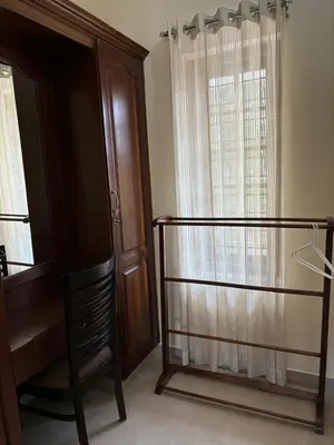 a room with a staircase and a chair and a window at Serene Nest Apartment-Kochi Airport in Nedumbassery
